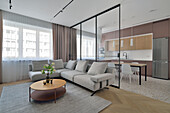 Moderne Wohnungseinrichtung mit offener Küche und Wohnbereich in Grau- und Holztönen
