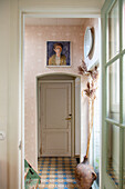 Hallway with patterned tiles and a picture above the door