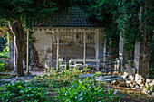 Rustic-style gazebo with benches and ivy growth