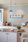 Bright country kitchen with kitchen island and plate rack