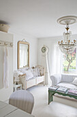 Bright living room in shabby chic style with chandelier and antique furniture