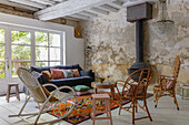 Living room with vintage chairs, fireplace and unplastered wall