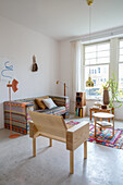 Living room with patterned sofa and light-coloured wooden furniture