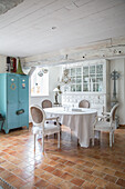 Country-style dining room with white display cabinet and blue locker