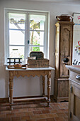 Rustic wooden table with vintage milk crate and bread in the country-style kitchen area