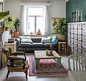 Living room with antique furniture, leather sofa and vintage cupboards