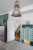 Study with filing cabinets and industrial-look lamp