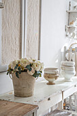 Vintage decor with a bouquet of roses and ceramics on an antique table