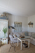 Living room in natural colours with corner sofa and rustic wall decor in vintage style