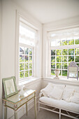 Bright room with white sofa and antique side table