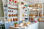 Bakery with open shelves filled with bread and groceries