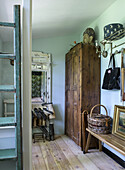 Rustic wardrobe with wooden floor, wooden cupboard and wall hook rail