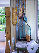 Rustic table with birdcage and traditional farmhouse chairs with hearts