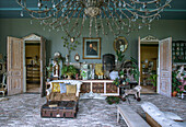 Vintage living room with large chandelier, plants and antique furniture