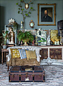 Living room with antique furniture, plants and paintings