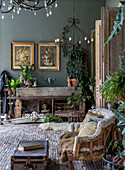 Rustic room with plants, antique furniture and chandelier