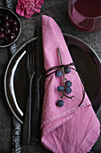 Sloe berries as table decoration, napkin coloured in sloe broth