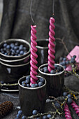 Candlestick filled with fresh sloe berries