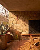 Outdoor area with brickwork and wooden furniture in Casa Cometa, Mexico