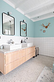 Wooden washstand with double washbasin and mirrors in modern bathroom