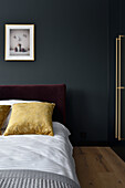 Elegantly designed bedroom with dark walls and gold-colored accents