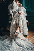 Bride in embroidered dress and heels with bow, vintage style