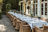 Festively laid table with rattan chairs outdoors