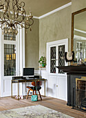 Study area in living room with antique chandelier and fireplace