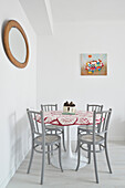 Dining area with round table and grey chairs
