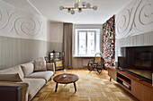 Living room with curved relief wall and parquet flooring