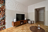 Living room with stylish wall decor and parquet flooring