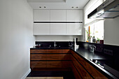 Modern kitchen with white uppers and dark base units
