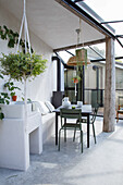 Conservatory with table, chairs, sink and plants