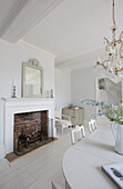 Bright room with fireplace, dining table and chandelier