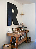 Bar area with workbench, coffee machine and large letter "R" on the wall