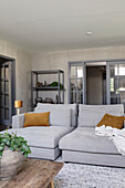 Living room in grey with armchairs, carpet and wooden table