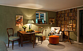 Cozy reading corner with wall of books and wooden furniture in the living room