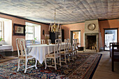 Dining room with historic charm, oriental carpet and antique fireplace