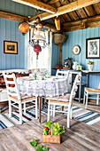 Country-style dining area with blue-painted wooden walls and rustic details