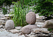 Stacked natural stones and ornamental grass in the rock garden