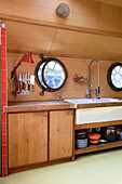 Kitchen area with porthole windows and sink