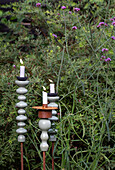 Candlesticks in different heights in the flowering garden bed