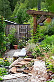 Green garden with wooden pergola and gravel path