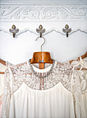 Lace dresses on decorative vintage-style hooks