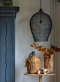 Table with autumnal decoration and lamp in a rustic room