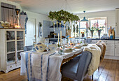 Country kitchen with table setting, candles and Christmas decorations