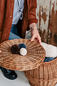 Person holding basket lid with home-made woollen pompoms