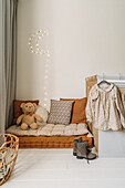 Cosy children's room corner with cushions and fairy lights in the shape of the moon