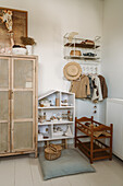 Children's room with rattan cupboard, doll's house and wardrobe