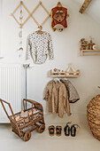 Wall of a children's room with wardrobe, shelves and clothes